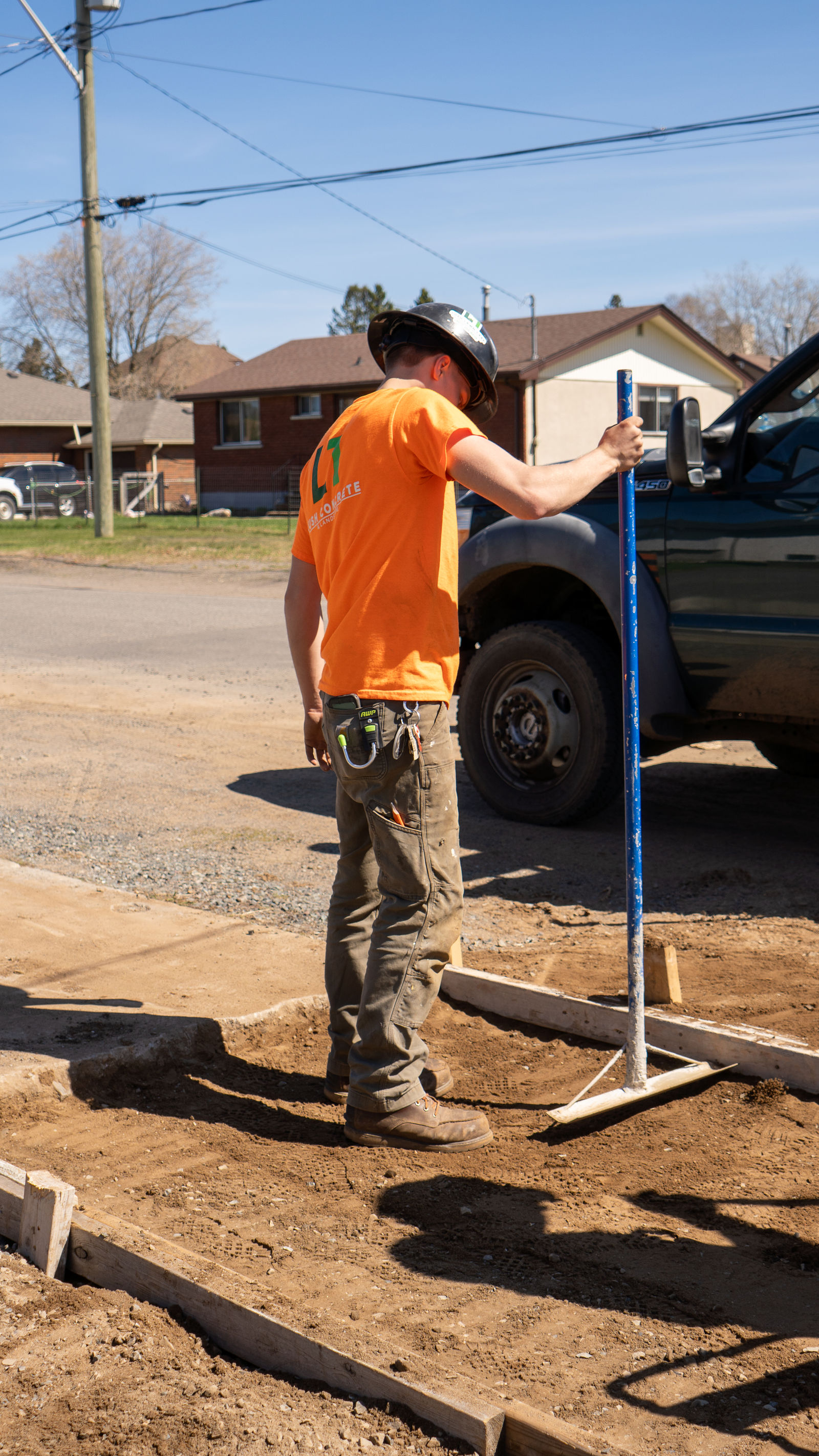 Setting screed rails on a formed walkway