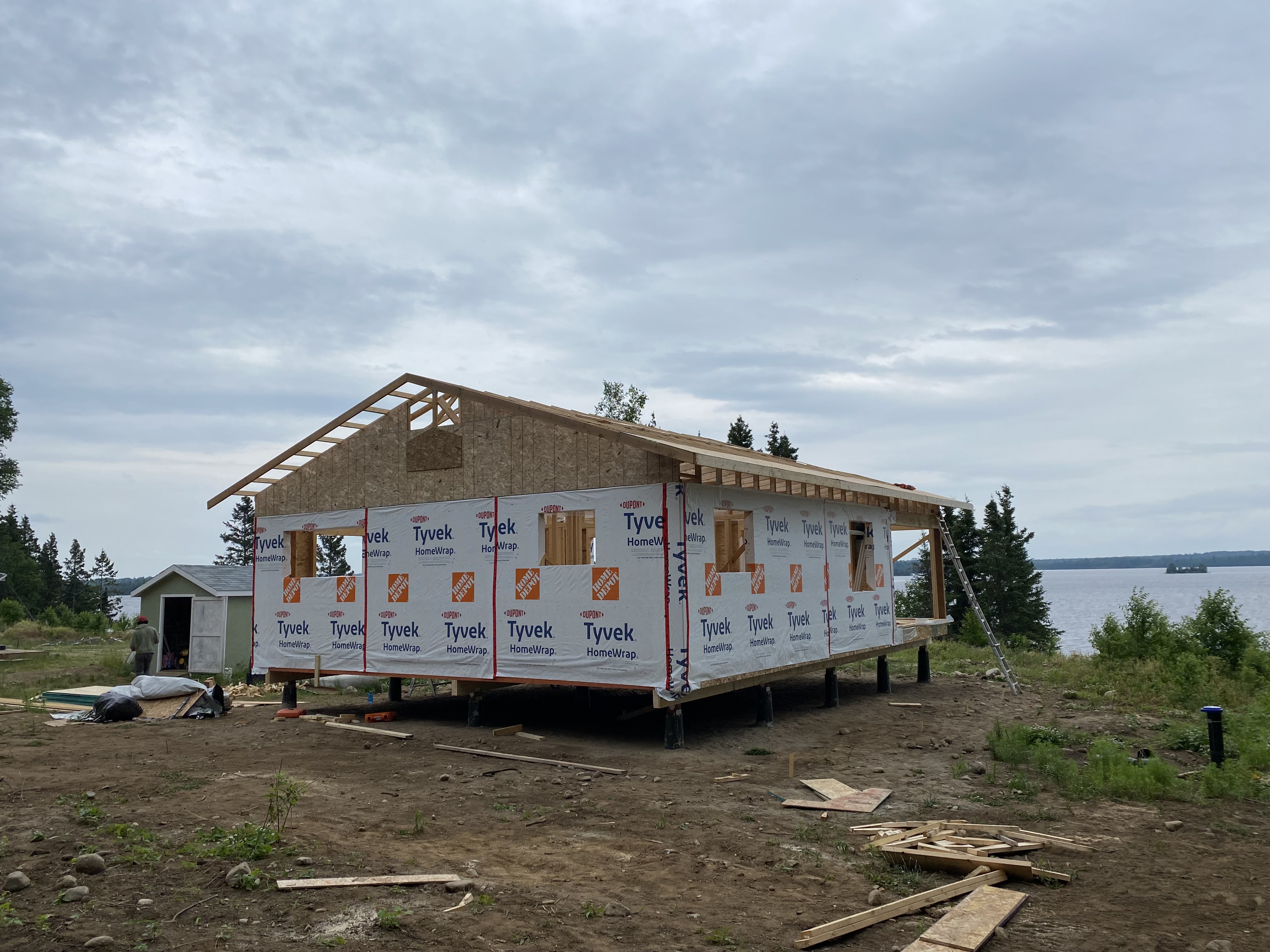Same lakeside cottage — gable end framed against the lake view