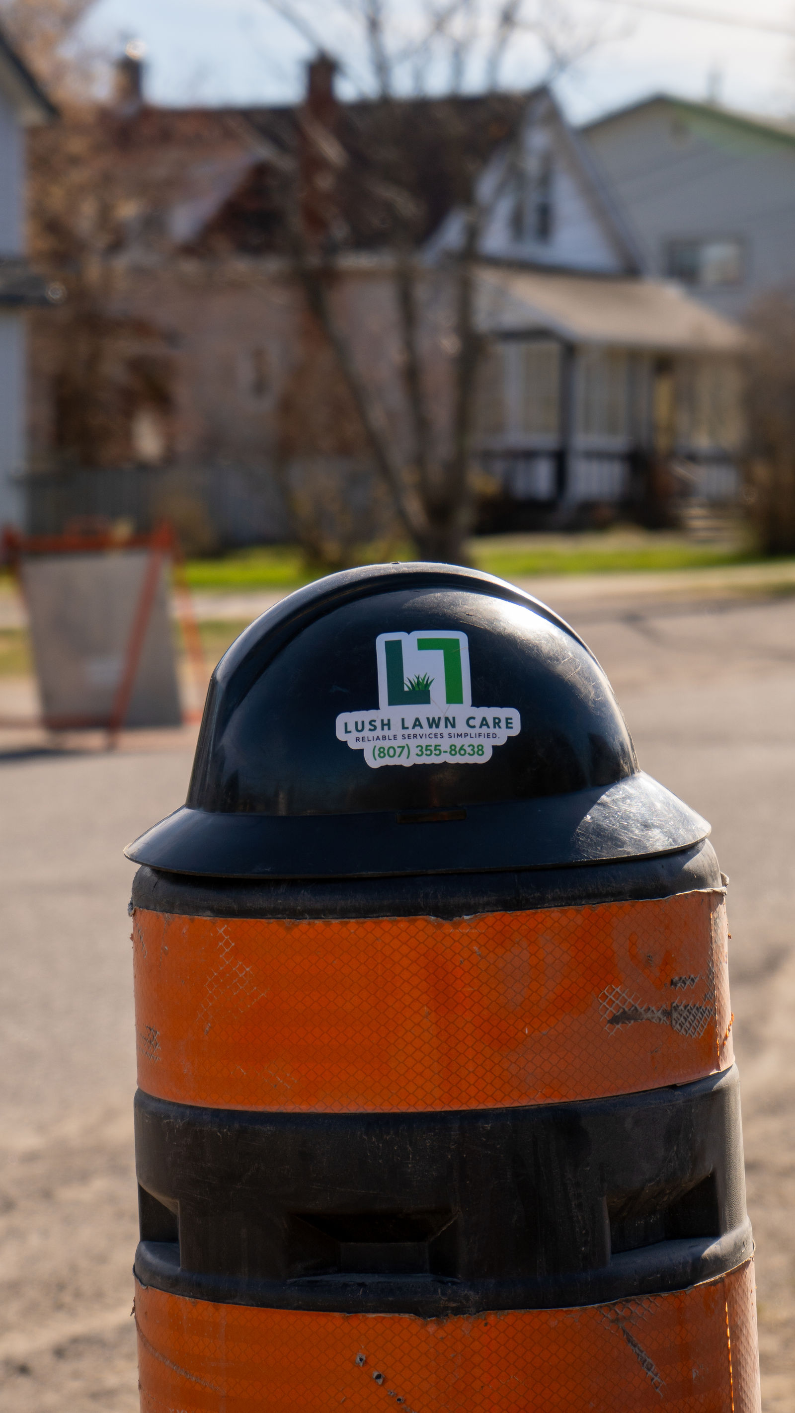 Lush-branded bollard on the curb
