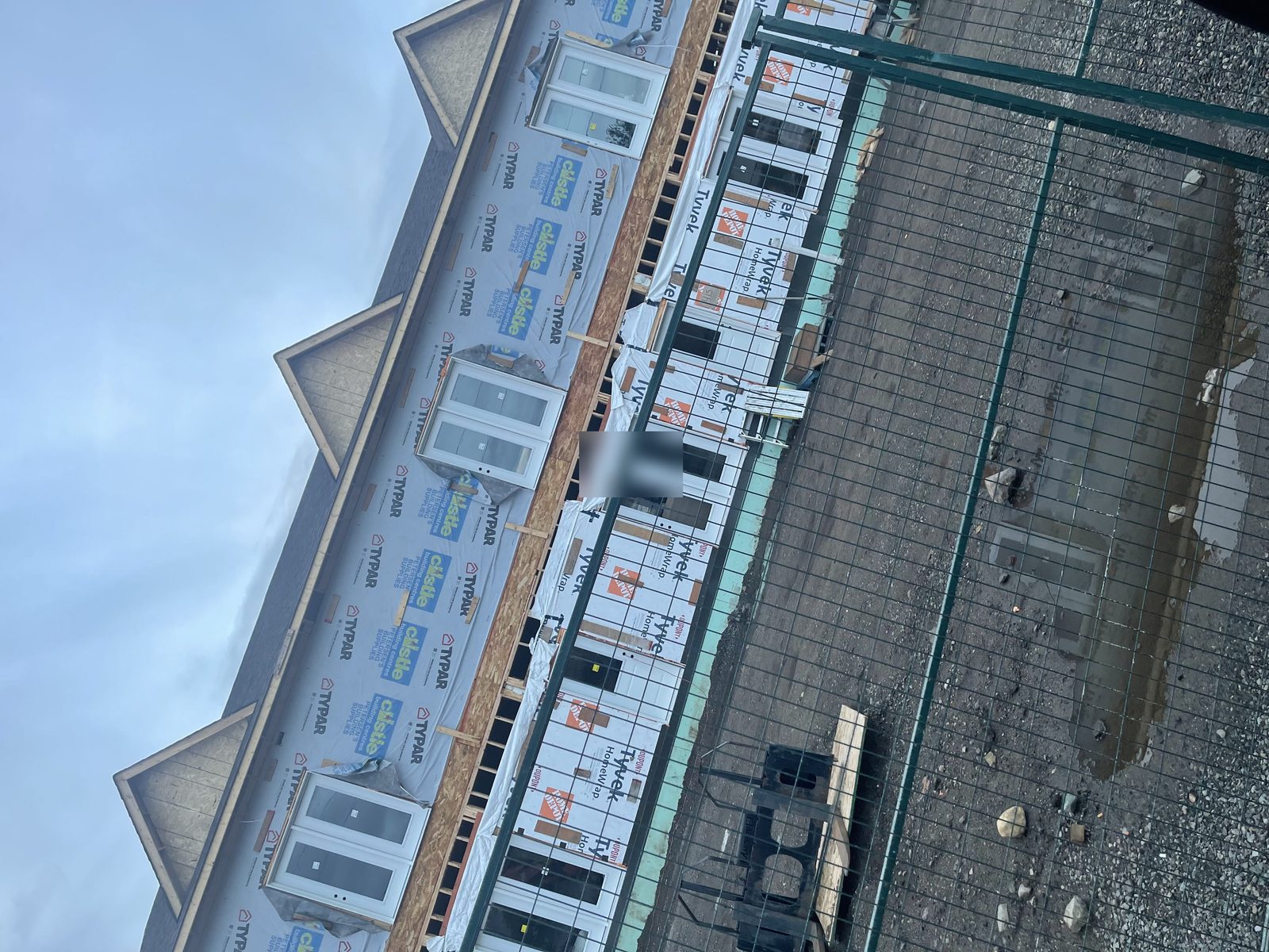 Two-storey with dormers, Typar and Tyvek wrap, windows and doors set