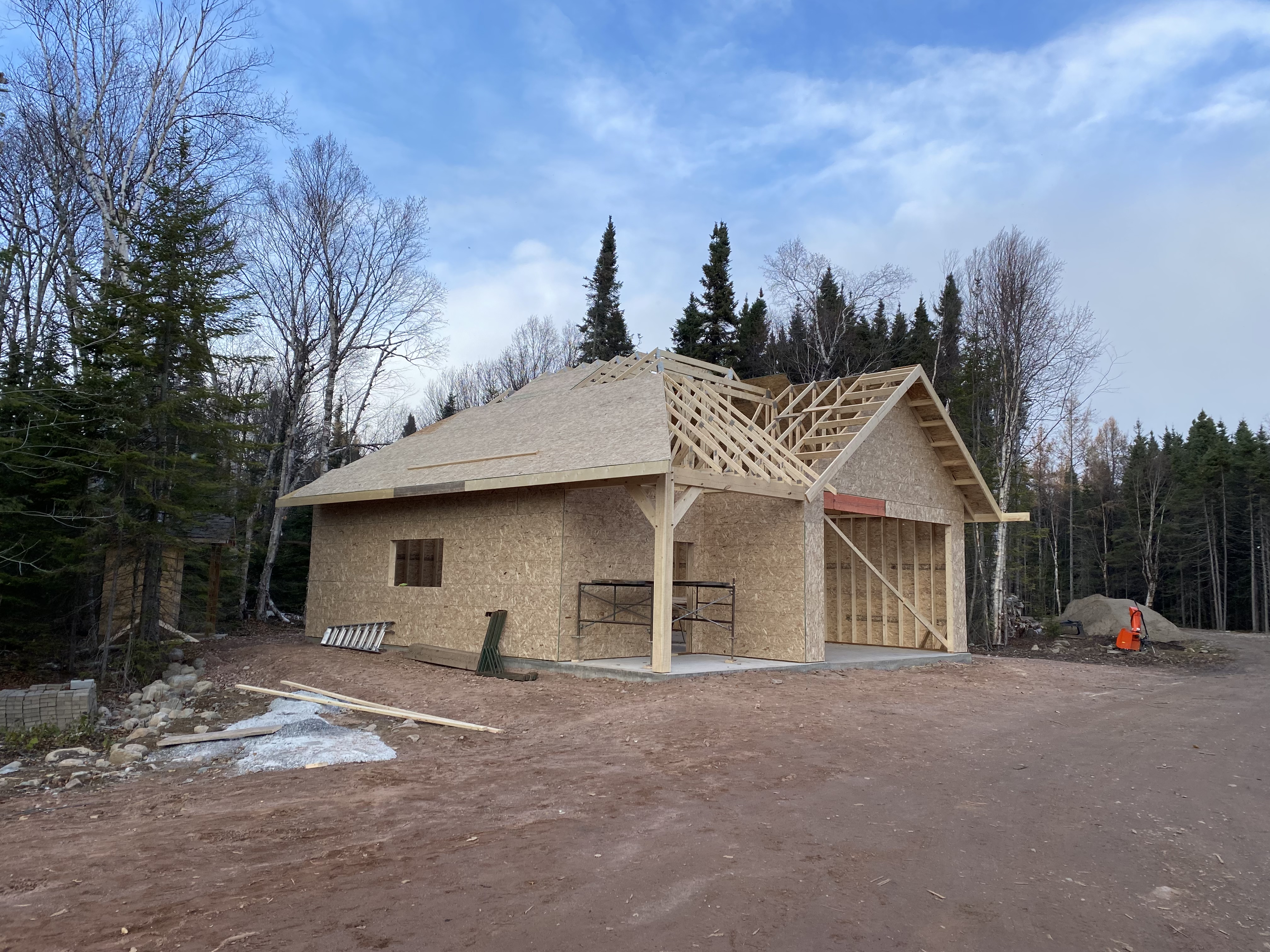 Garage and shop with timber post entry and partial roof sheathing