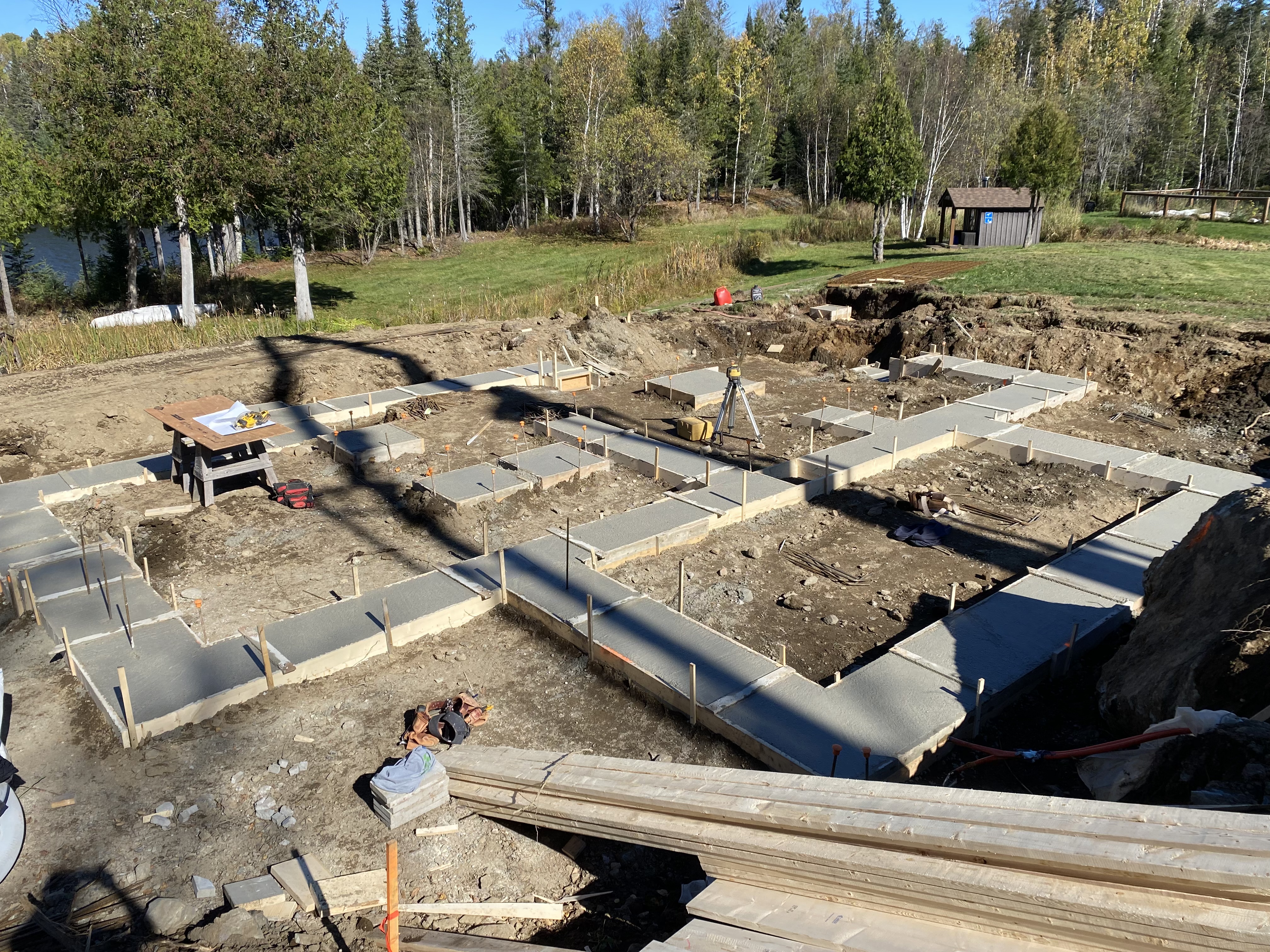 Foundation and footings poured, laser level set up for grade