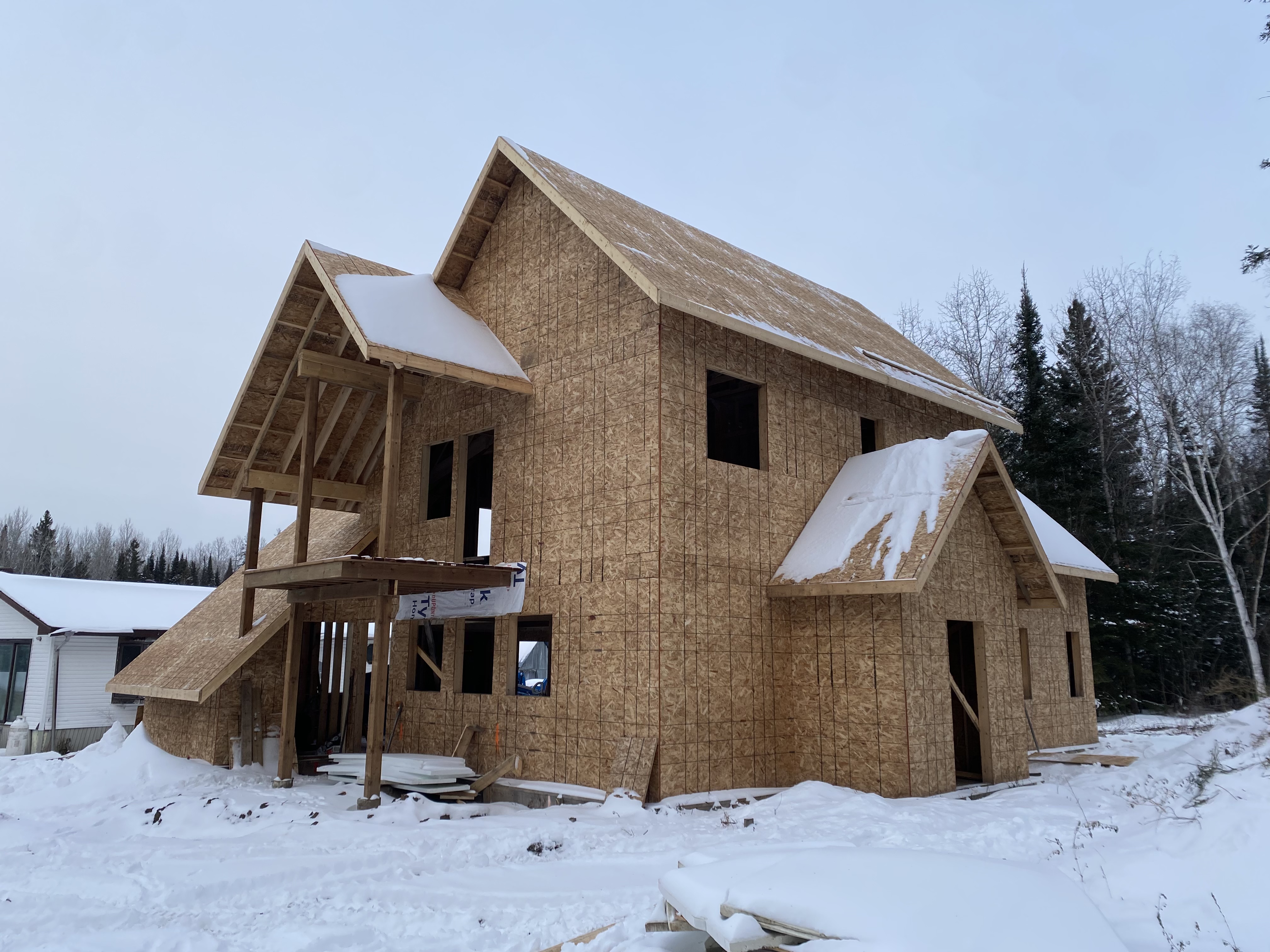 Side elevation of the winter build with snow across the roof planes